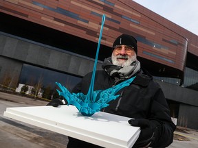 UK-based artist Gerry Judah holds a model of the new public art installation he created for the plaza of the BMO Centre expansion on Wednesday, November 1, 2023. Called Spirit of Water, the 70-foot-tall, 112,000-pound steel sculpture will be installed in the spring of 2024.