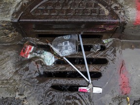 EDMONTON ALBERTA: JULY 5, 2022. Single use plastic seen in a storm drain along Whyte Ave. in Edmonton Alberta, July 5, 2022. City council on Monday voted to ban plastic bags, straws, and other single-use items. Jason Franson for Postmedia