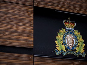 The RCMP logo is seen outside Royal Canadian Mounted Police "E" Division Headquarters, in Surrey, B.C., on April 13, 2018. Two people are dead and three were sent to hospital after a head-on crash in southeast Alberta on Tuesday night.