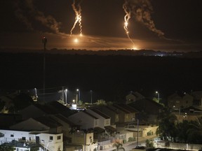 Global Affairs Canada says that to date, 367 Canadians, permanent residents and their relatives have been able to escape via the Rafah border crossing, most recently including two people on Wednesday and 10 on Monday. Flares rise over the Gaza Strip, as seen from southern Israel, Thursday, Nov. 16, 2023.