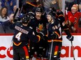 Calgary Flames forward Dillon Dube (29) celebrates a goal against the Vancouver Canucks with teammates at Scotiabank Saddledome in Calgary on Thursday, Nov. 16, 2023.