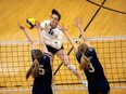 The Mount Royal University Cougars’ Haley Roe spikes the ball against the Trinity Western University Spartans during the U SPORTS Women’s Volleyball Championship match at the Jack Simpson Gym at the University of Calgary on March 27, 2022.