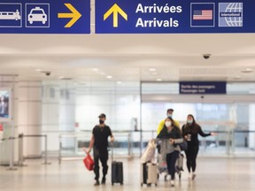 Travellers arrive at Trudeau Airport in Montreal, Wednesday, April 20, 2022.