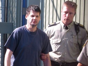 Randall Hopley is led out of the Cranbrook, B.C., courthouse on Wednesday, Sept. 14, 2011. British Columbia's premier says he is "deeply disturbed" that Hopley, a high-risk sex offender, is on the loose after failing to return to his halfway house in Vancouver this weekend.