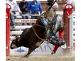 Dakota Buttar from Eatonia, Sask., gets bucked riding Back Flip during the Stampede Bull Riding Championship at Day seven of the Calgary Stampede Rodeo in Calgary on Thursday, July 14, 2022. Darren Makowichuk/Postmedia