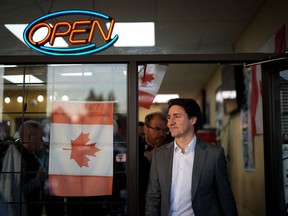 Prime Minister Justin Trudeau leaves a small business after stopping to meet the people inside, in Surrey, B.C., on Tuesday, November 14, 2023. Vancouver police say 100 officers were sent to a restaurant where Trudeau was dining Tuesday night after it was surrounded by protesters.