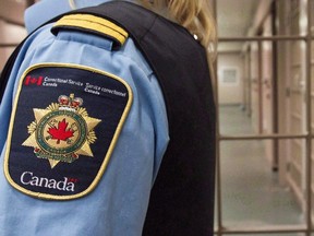 A correctional officer looks on at the Collins Bay Institution in Kingston, Ont., on Tuesday, May 10, 2016, during a tour of the facility.