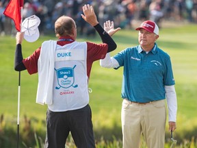 Ken Duke from Stuart, Florida, celebrates with his caddie after winning the Shaw Charity Classic at Canyon Meadows golf and country club on Sunday, August 20, 2023. The event raised a record $18.7 million.
