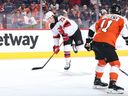 PHILADELPHIA, PENNSYLVANIA - NOVEMBER 30: Tyler Toffoli #73 of the New Jersey Devils skates with the puck past Travis Konecny #11 of the Philadelphia Flyers during the first period at the Wells Fargo Center on November 30, 2023 in Philadelphia, Pennsylvania.