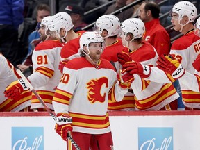 Blake Coleman #20 of the Calgary Flames celebrates with his teammates after scoring against the Colorado Avalanche in the second period at Ball Arena