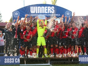 Captain Marco Carducci hoists the Canadian Premier League Shield as Cavalry FC celebrates winning the regular-season title following a match against Pacific FC on ATCO Field at Spruce Meadows on Saturday, Oct. 7, 2023.