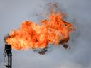 A flare stack burns off excess gas at a processing facility near Crossfield, Alta., Tuesday, June 13, 2023. Canada's oil and gas industry says the emissions cap framework announced Thursday by Ottawa could result in significant production curtailments by companies.