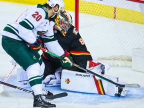 Calgary Flames goaltender Dan Vladar gets a glove on this shot by Minnesota Wild forward Pat Maroon at Scotiabank Saddledome in Calgary on Tuesday, Dec. 5, 2023.