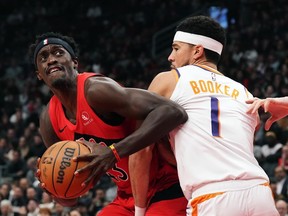 A weekend off gave Toronto Raptors' Pascal Siakam time to rest, recharge, and reflect on the first quarter of the NBA season. Siakam (43) tries to get around Phoenix Suns' Devin Booker (1) during first half NBA basketball action in Toronto, Wednesday, Nov. 29, 2023.