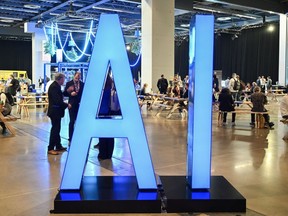An illuminated AI sign during the All In event in Montreal, Quebec, Canada, on Thursday, Sept. 28, 2023.