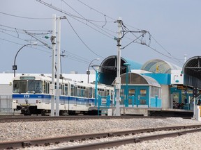 An LRT train pulls into Coliseum LRT Station.