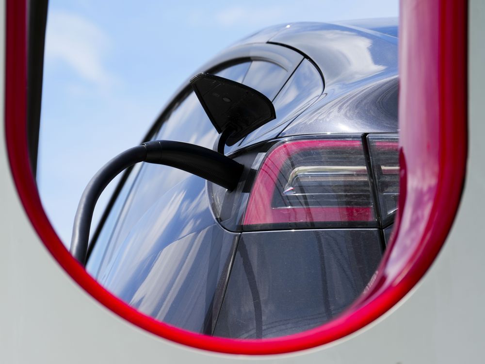 An electric vehicle is charged in Ottawa on Wednesday, July 13, 2022. Auto manufacturers will have three years to start showing a sizable increase in electric vehicle sales as the federal government moves to finalize its new EV mandate this week.