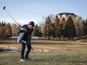 A woman hits a tee shot on the Shaganappi Point golf course in Calgary on Dec. 5, 2023.