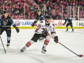 Calgary Hitmen Sean Tschigerl moves with the puck against Winnipeg Ice during the Pink Shirt Day