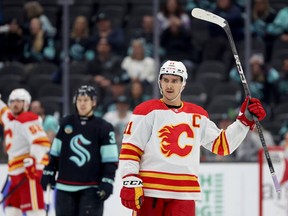 Mikael Backlund #11 of the Calgary Flames celebrates an empty-net goal against the Seattle Kraken during the third period at Climate Pledge Arena