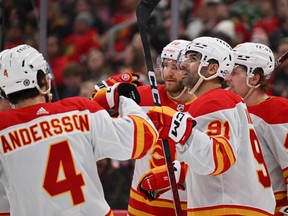 Nazem Kadri #91 of the Calgary Flames celebrates with teammates after scoring his second goal of the game in the third period against the Chicago Blackhawks on January 07, 2024 at United Center in Chicago, Illinois.