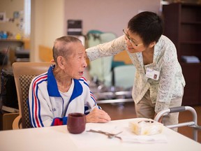 A recreation therapist speaking with a long-term care resident at Covenant Health. SUPPLIED