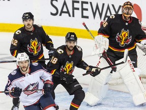 MacKenzie Weegar, Oliver Kylington, and Jacob Markstrom