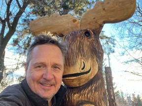 Peter Bennett stands with his “Moose on the Loose” sculpture. The chainsaw-carved piece was stolen from Bennett’s front yard in Sylvan Lake on Jan. 3.