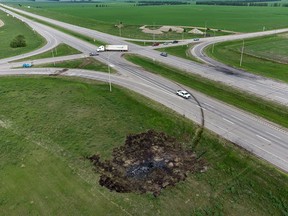 A scorched patch of ground where a minibus carrying seniors ended up after colliding with a transport truck and burning is seen on the edge of the Trans-Canada Highway where it intersects with Hwy 5, west of Winnipeg near Carberry, Man., June 16, 2023.