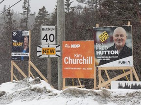 Campaign signs for the provincial byelection for the riding of Conception Bay East-Bell Island, N.L. The sign for Liberal candidate Fred Hutton is on the right, seemingly downplaying his party affiliation.