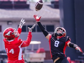 Calgary Stampeders defensive back Nick Statz reaches out to try and block a pass to wide receiver Clark Barnes during team practice at McMahon Stadium