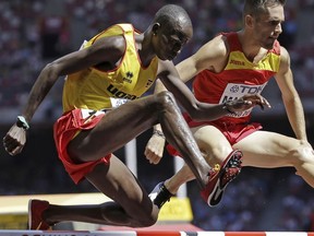 Uganda's Benjamin Kiplagat, front, competes in round one of the men's 3000m steeplechase during the World Athletic Championships at the Bird's Nest stadium in Beijing.