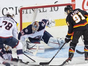 Columbus Blue Jackets goaltender Daniil Tarasov blocks a play by Calgary Flames center Nazem Kadri in the third period at the Saddledome on Thursday