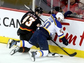 Calgary Flames Adam Klapka battles St. Louis Blues Brayden Schenn in second period NHL action at the Scotiabank Saddledome