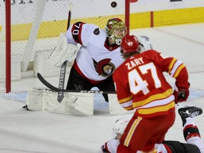 Calgary Flames Connor Zary scores on Ottawa Senators goalie Joonas Korpisalo in first period NHL action at the Scotiabank Saddledome in Calgary