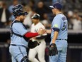 Toronto Blue Jays catcher Alejandro Kirk and relief pitcher Erik Swanson shake hands after defeating the New York Yankees last year.