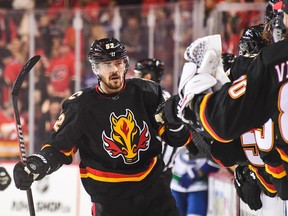 MacKenzie Weegar #52 of the Calgary Flames celebrates with the bench after scoring against the Vancouver Canucks during the first period