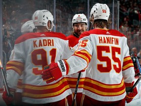 The Calgary Flames celebrate a goal scored by Andrei Kuzmenko #96 during the third period against the New Jersey Devils at Prudential Center