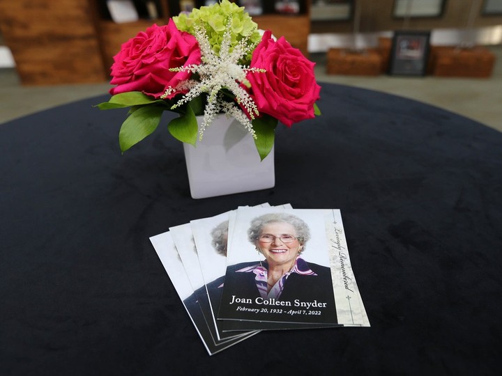  Service cards and a table decoration are displayed in front of memorabilia arranged at the University of Calgary on Friday, October 28, 2022. Joan Snyder’s estate donated $67.5 million to UCalgary, part of a total legacy of more than $100 million to charities and community organizations.