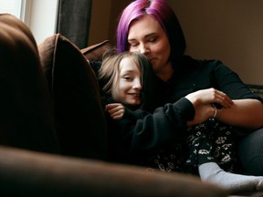 Samantha Jones, 10, and her mother Catie Jones pose for a photo in the living room of their Sherwood Park home, Friday Feb. 2, 2024. Jones has started a petition to safeguard transgender children's rights to self-identify and bodily autonomy in Alberta.