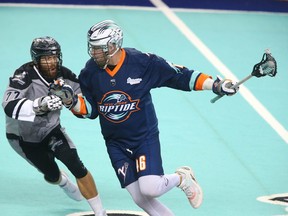 Roughnecks Zach Currier (L) guards Riptides' Kiel Matisz during NLL action between the Calgary Roughnecks and New York Riptide in Calgary