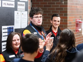 Special Olympians (L-R) Siobhan Zobatar, Darby Taylor, and Damion Chiodo high-five students of Riverside School during the RBC Special Olympics Athlete School Visit on Thursday, February 8, 2024.