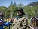 Singer Corb Lund, centre, speaks to media on land proposed for coal mine development in the eastern slopes of the Livingstone range southwest of Longview, Alta., Wednesday, June 16, 2021. Lund is criticizing the province's energy minister for advising its energy regulator to accept initial applications for a coal mine project in the eastern slopes of the southern Rockies.