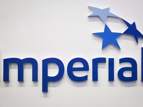 Imperial Oil Ltd. raised its quarterly dividend by 20 per cent as it reported a fourth-quarter profit of $1.37 billion, down from $1.73 billion a year earlier. An Imperial Oil logo is shown at the company's annual meeting in Calgary on Friday, April 28, 2017.