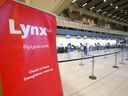 A deserted Lynx Air check-in desk is shown at the Calgary International Airport on Friday.