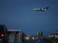 A Westjet Bombardier Q400 airplane crosses over 100 Avenue just before landing at Grande Prairie Airport on Wednesday July 22, 2015 in Grande Prairie, Alta.