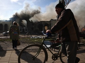 Local residents walk past the railway station destroyed by a Russian missile attack in Kostyantynivka, Donetsk region, on February 25, 2024.