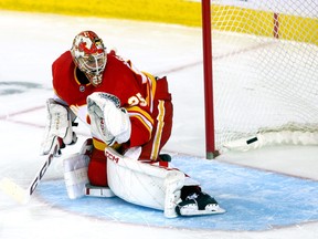 Calgary Flames goalie Jacob Markstrom is scored on by Seattle Kraken forward Jared McCann.