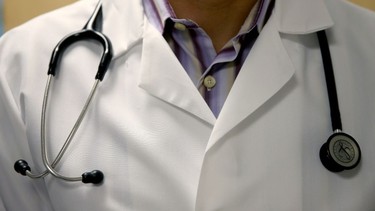 A doctor wears a stethoscope as he see a patient for a measles vaccination during a visit to the Miami Children's Hospital on June 2, 2014 in Miami, Florida.