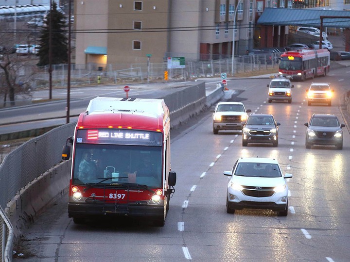  Commuters take a Red Line shuttle bus in southwest Calgary on Monday, November 27, 2023.